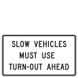 Slow Vehicles Must Use Turn Out Ahead Sign