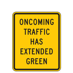 Oncoming Traffic Has Extended Green Warning Signs